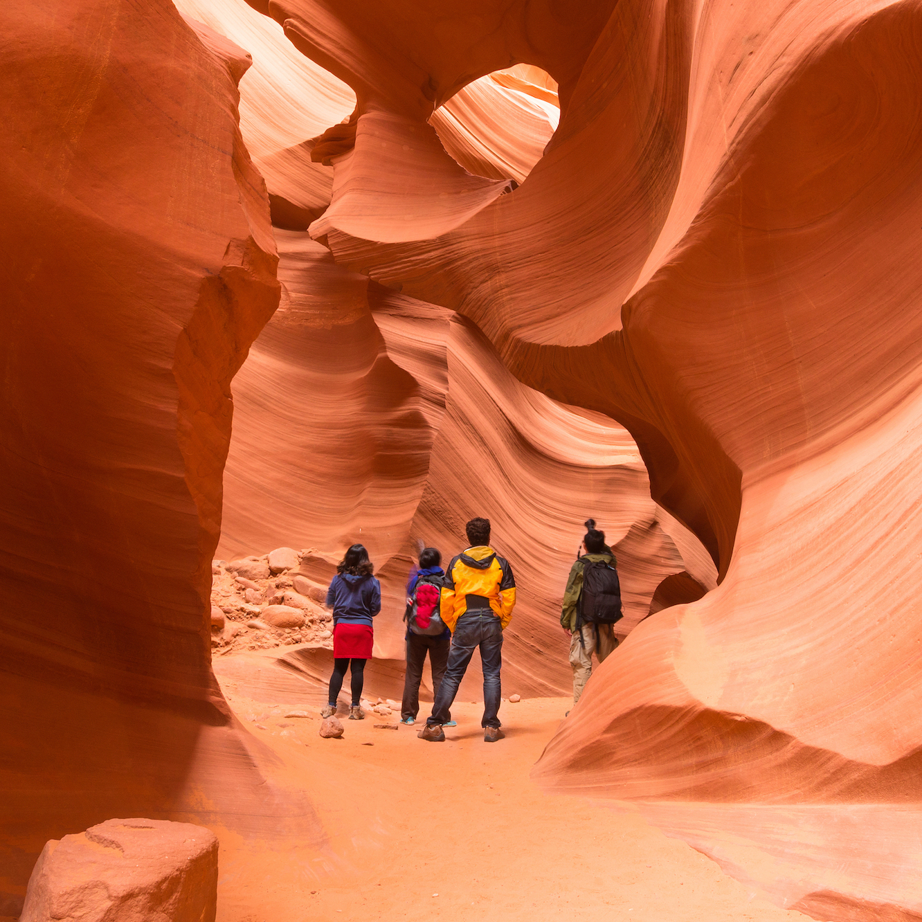 four people in a red canyon