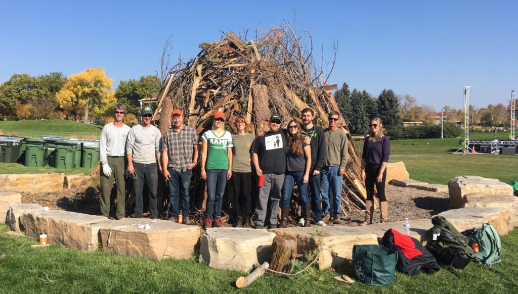 Group in front of a large slash pile.