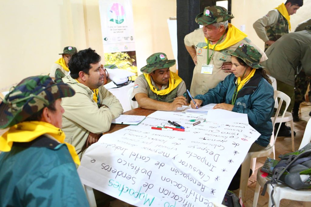 a group of people writing on a poster