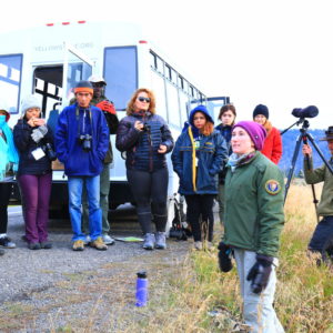 a group of students beside a bus in yellowstone