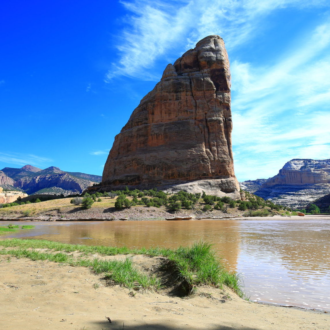 a large rock besides a river