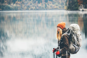 Girl backpacking by lake
