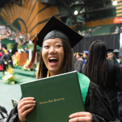 Warner graduate excitedly showing her diploma