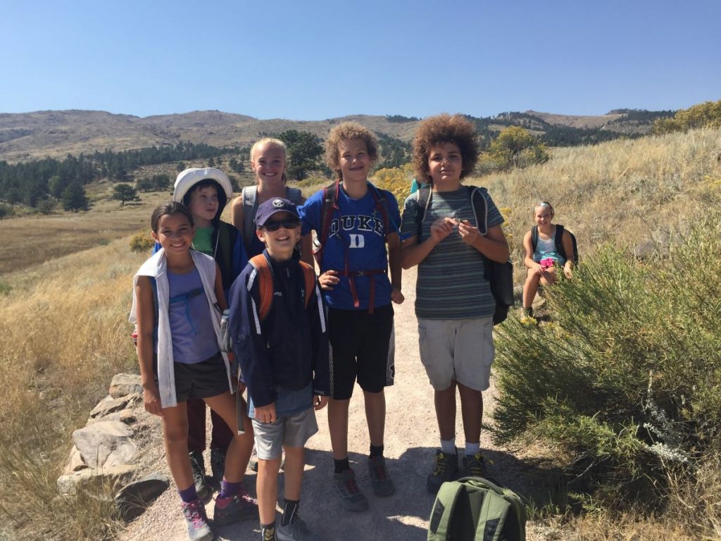 A group of kids pause while hiking in the foothills