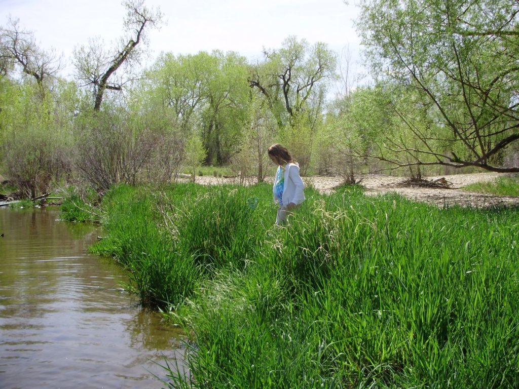 A child walks near the river