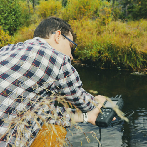 Professor of sustainability in ecosystem sciences monitors water quality in the field