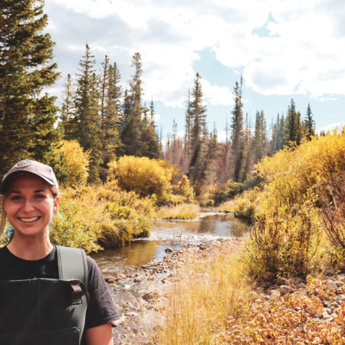 Ecosystem Science and Sustainability student from Colorado State University poses in the field near the Cache La Poudre River in Fort Collins, Colorado