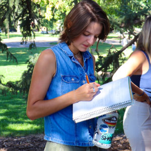 CSU ESS Accelerated Master's Student takes notes outside in Colorado.