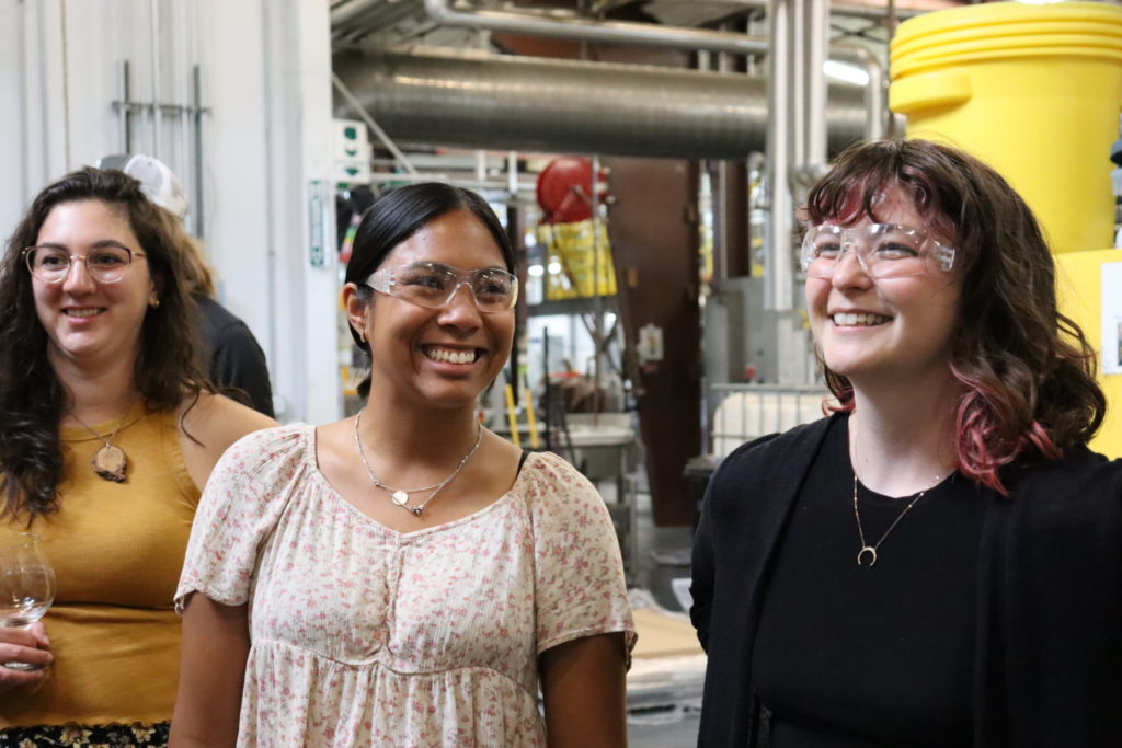 Three women laughing on a brewery tour about sustainability in Fort Collins, CO.